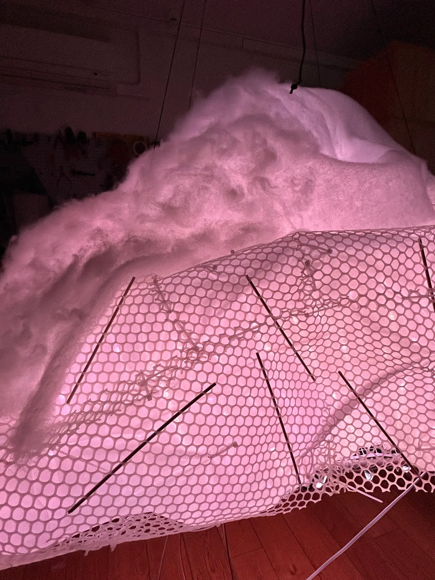 The rebuilt cloud glowing pink, with its layers of wadding and mesh visible at the edge.