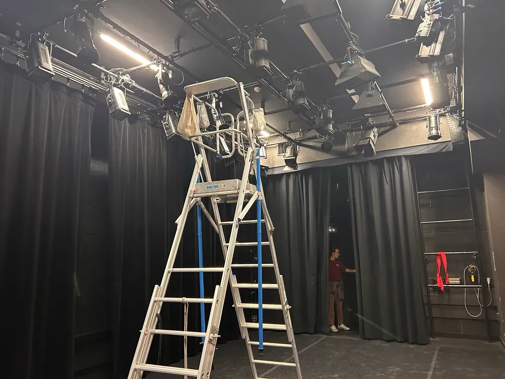 A tall ladder beneath the lighting rig in the black-box theatre at ENS.