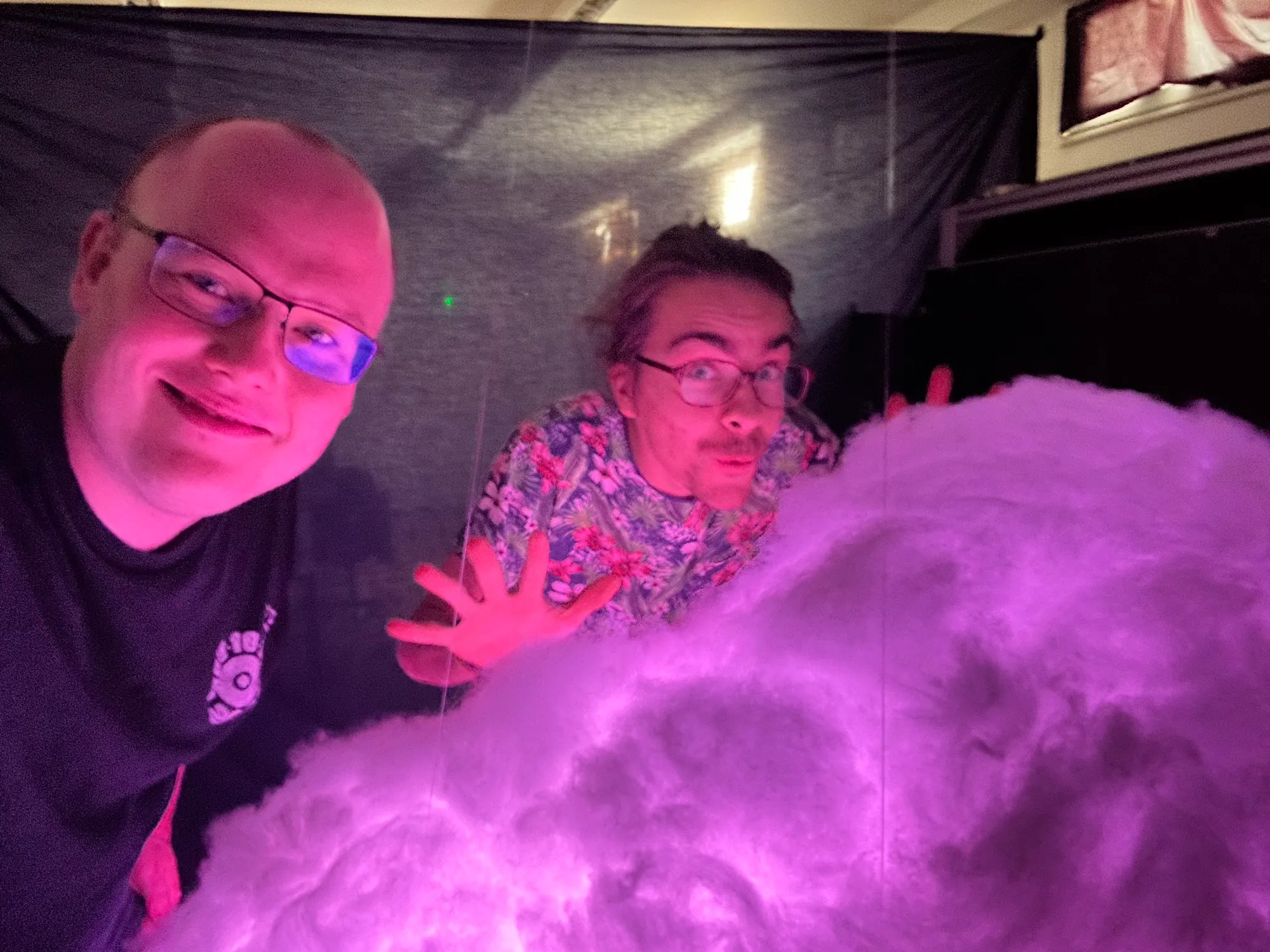 A grinning selfie of the two of us beside the cloud, glowing pink.
