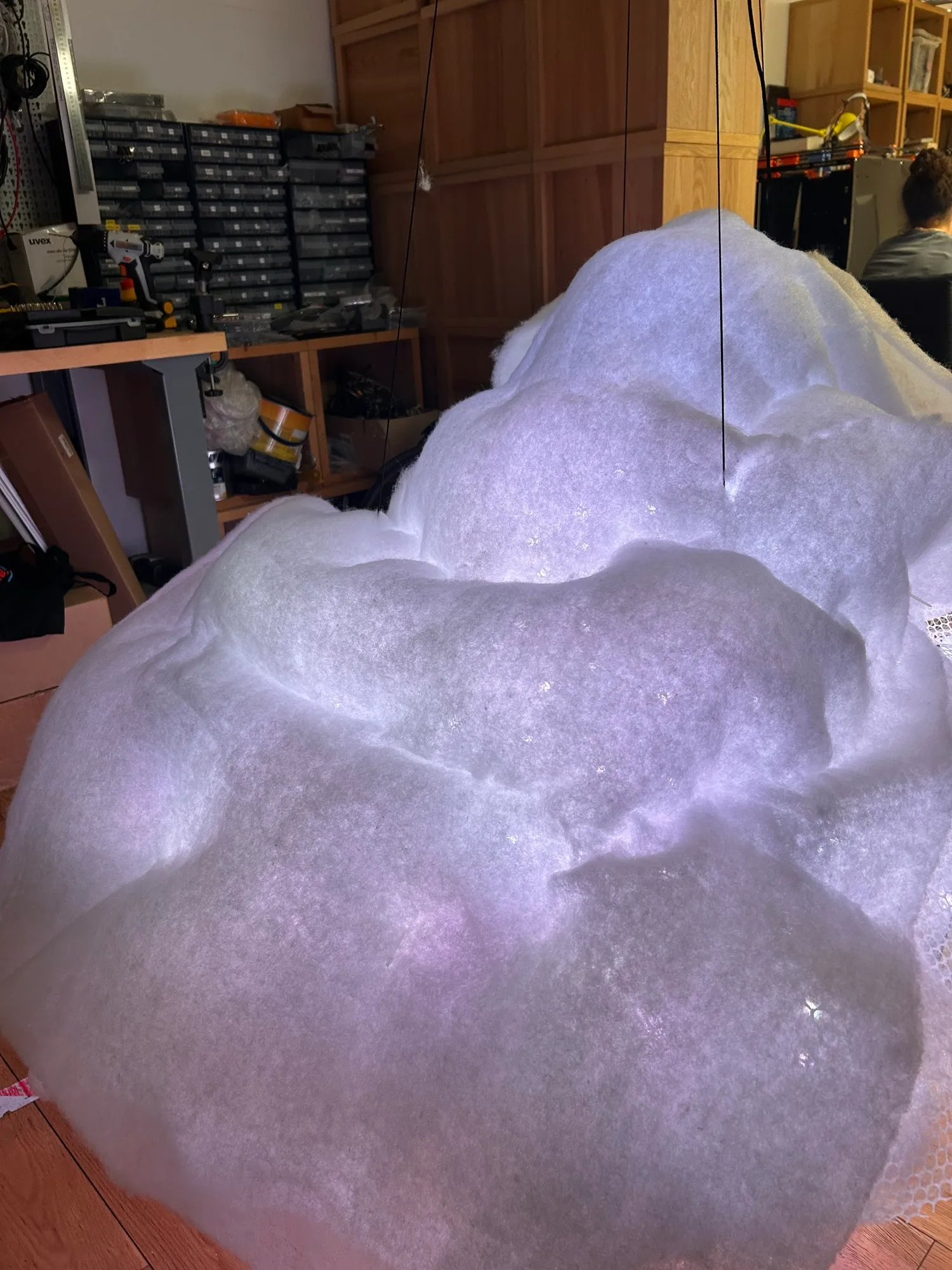 The cloud wrapped in thick polyester wadding, glowing pale lilac.