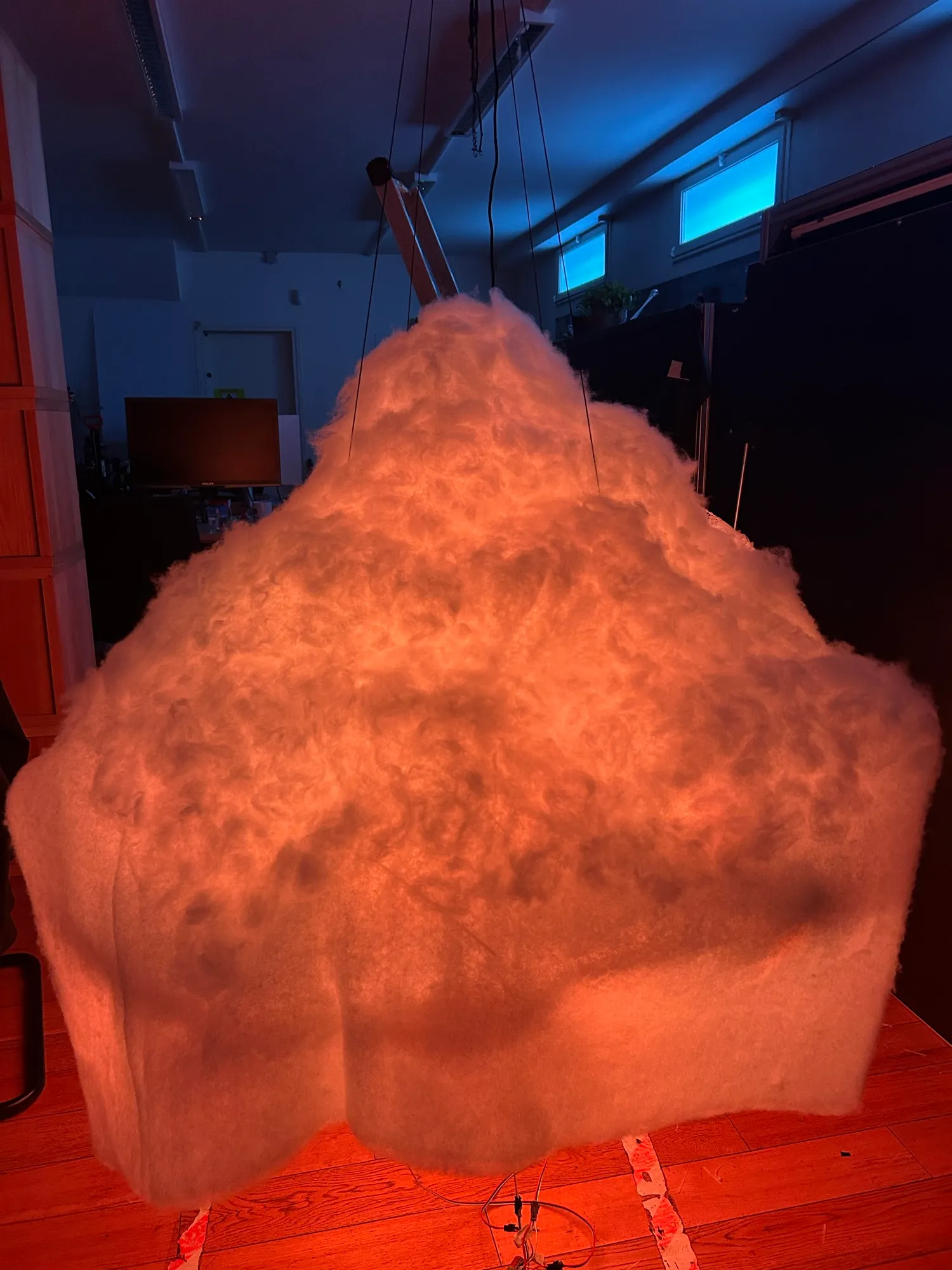 The textured cotton surface, glowing warm peach.